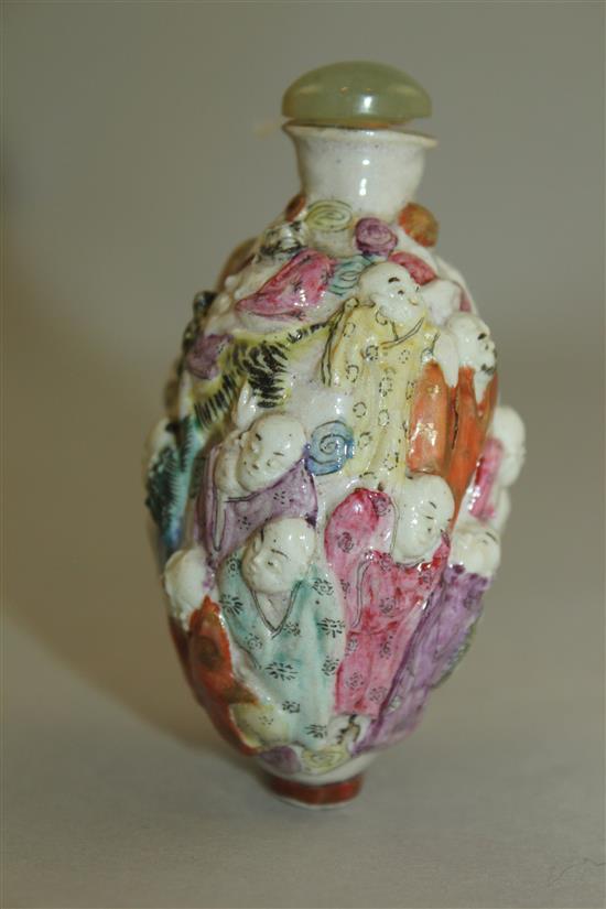 A Chinese moulded famille rose eighteen luohan snuff bottle, Qianlong seal mark, 1820-1850, 7.4cm